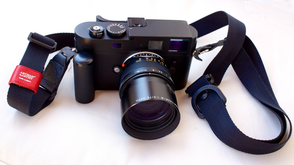   My  Monochrom with 75mm APO Summicron. Note the old M8 grip and the Thumbs Up grip attached to the hot-shoe.    I have since replaced the Artisan and Artist slider strap with one of my favoured braided straps from Barton1972.  
